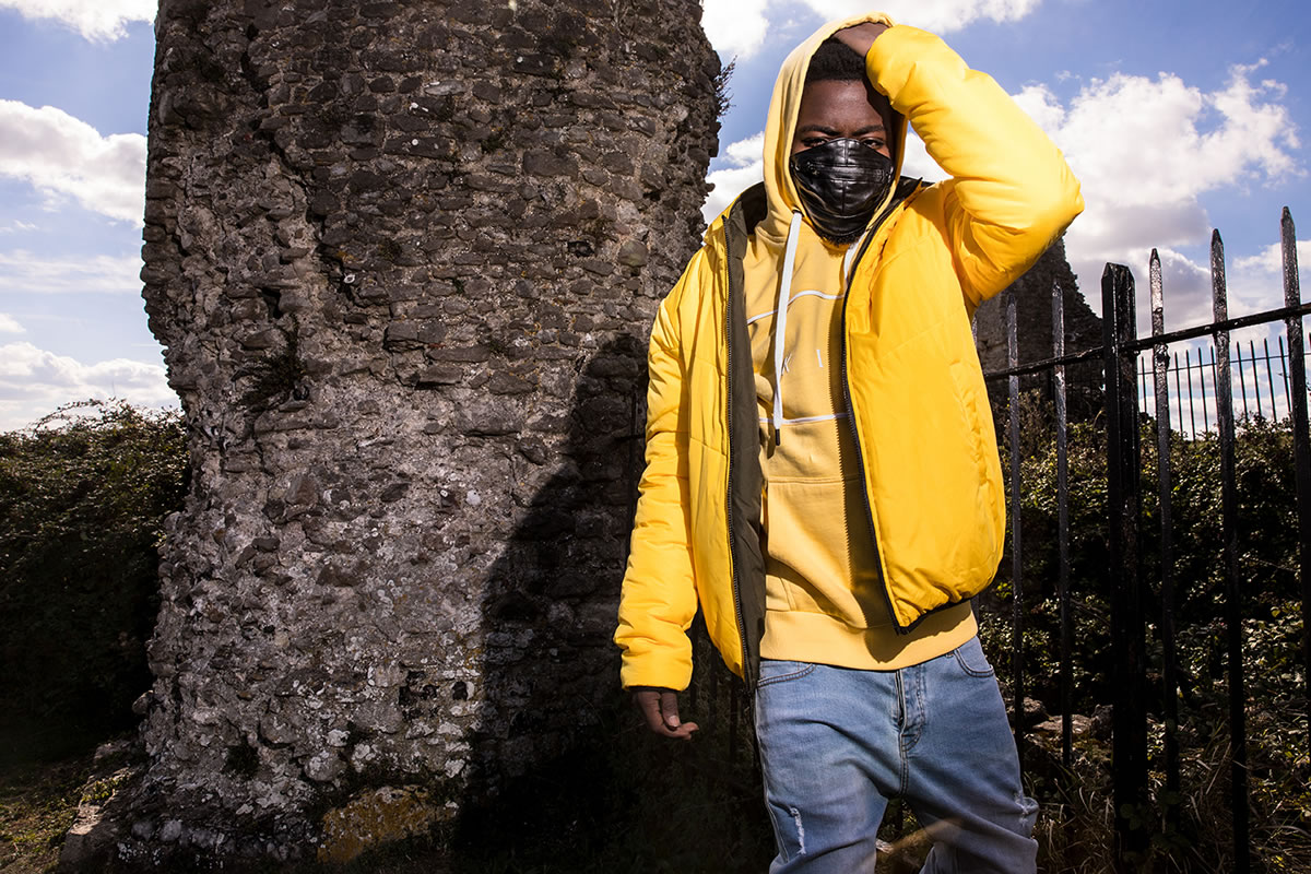 Fire Chulo wearing King Apparel citrus Blackwall down jacket and citrus Stepney hoodie