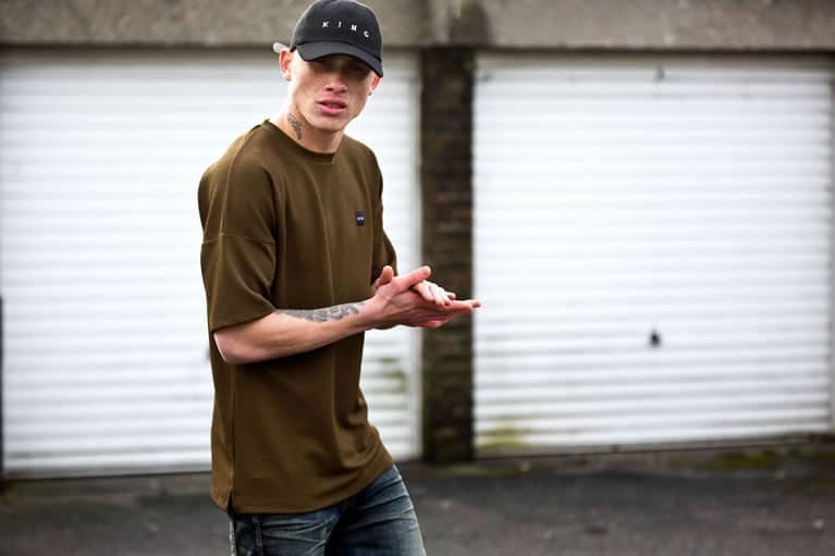 Model wears curved peak cap and t-shirt from King Apparel Autumn / Winter 2017 collection
