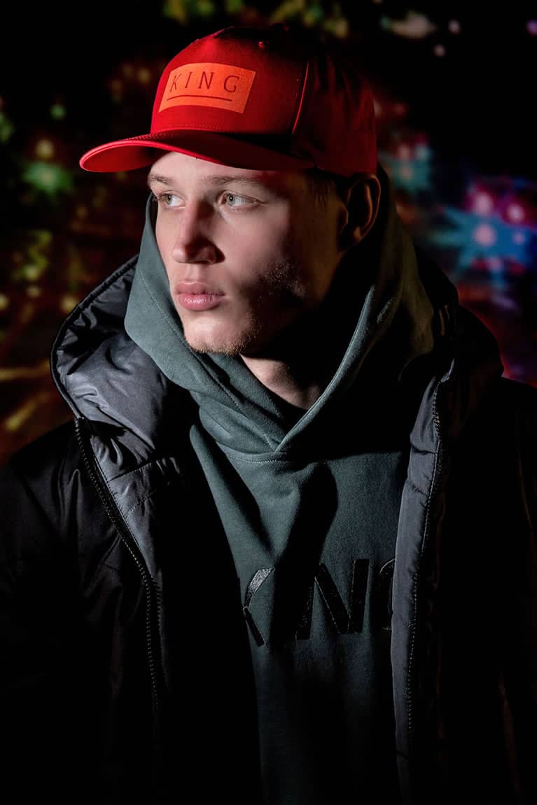 Model wears snapback cap, hoodie and jacket from King Apparel Autumn / Winter 2018 collection