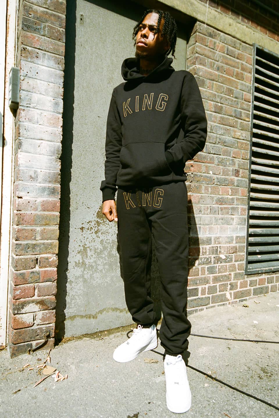 Kyro Keyz wears King Apparel Staple tracksuit in black