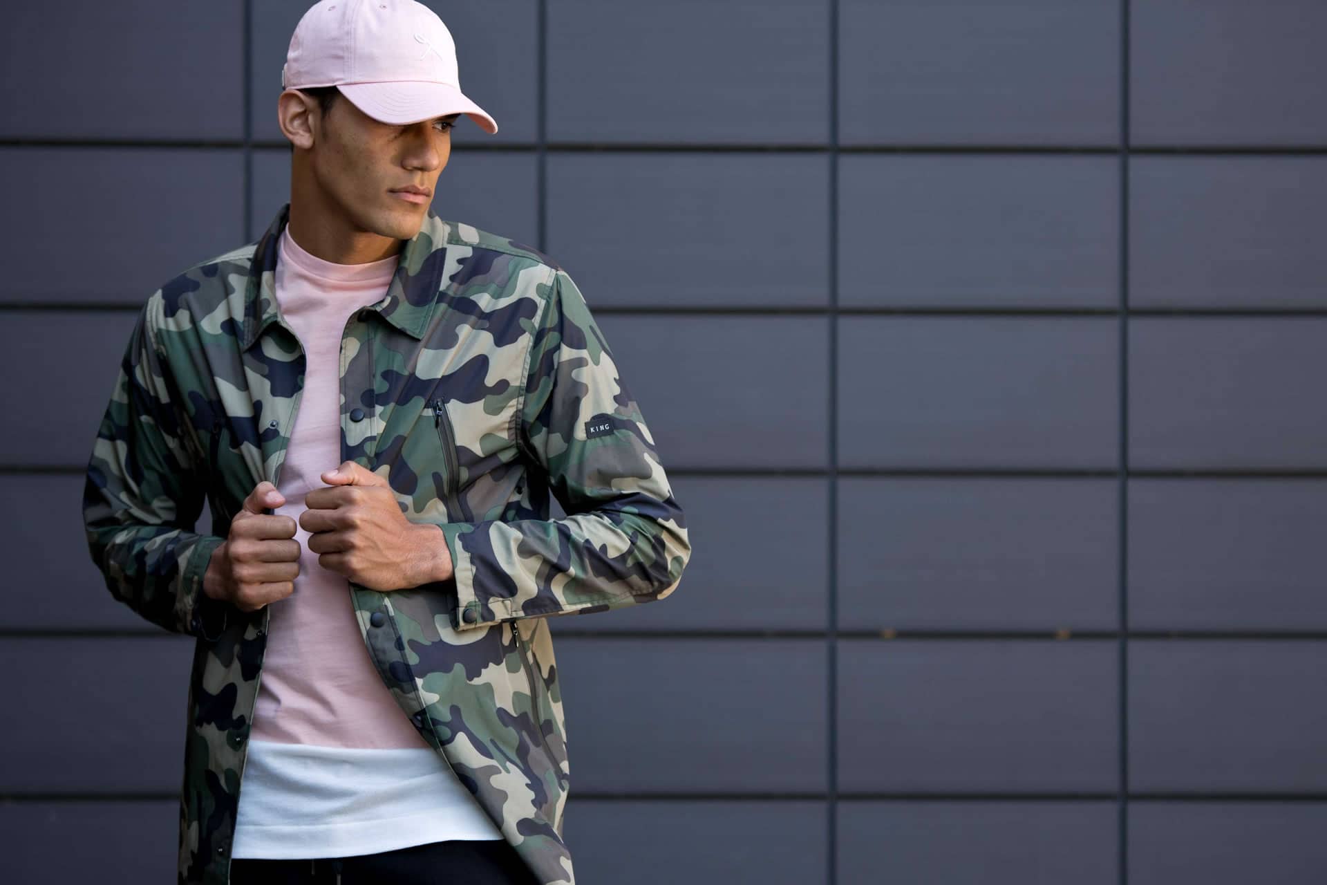 Model wears curved peak cap, t-shirt and jacket from King Apparel Spring / Summer 2017 collection