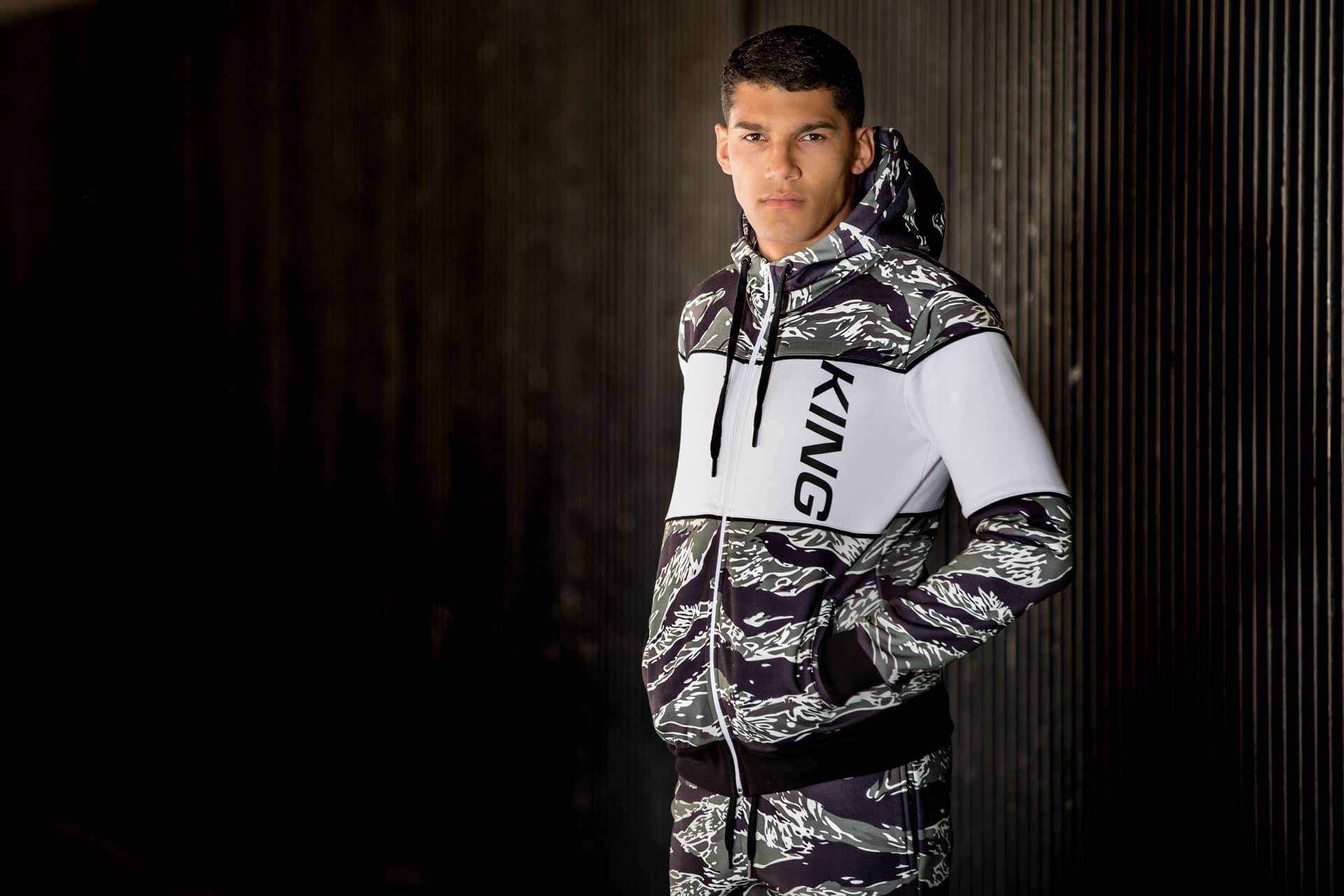 Model wears King Apparel Manor tracksuit in tiger camo