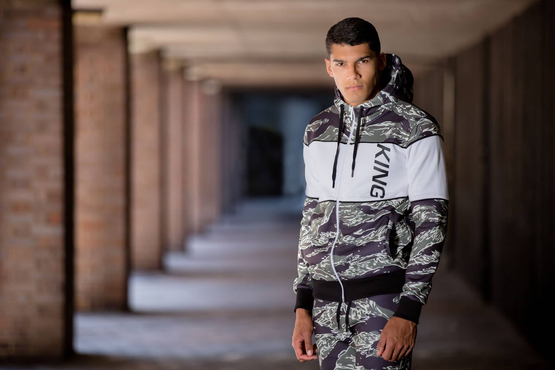 Model wears King Apparel Manor tracksuit in tiger camo