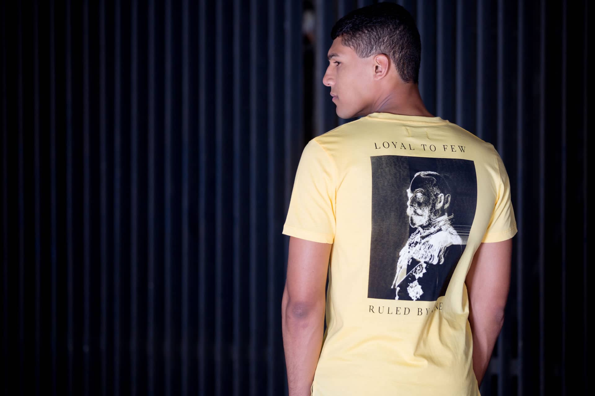 Model wears King Apparel Earlham t-shirt in citrus yellow