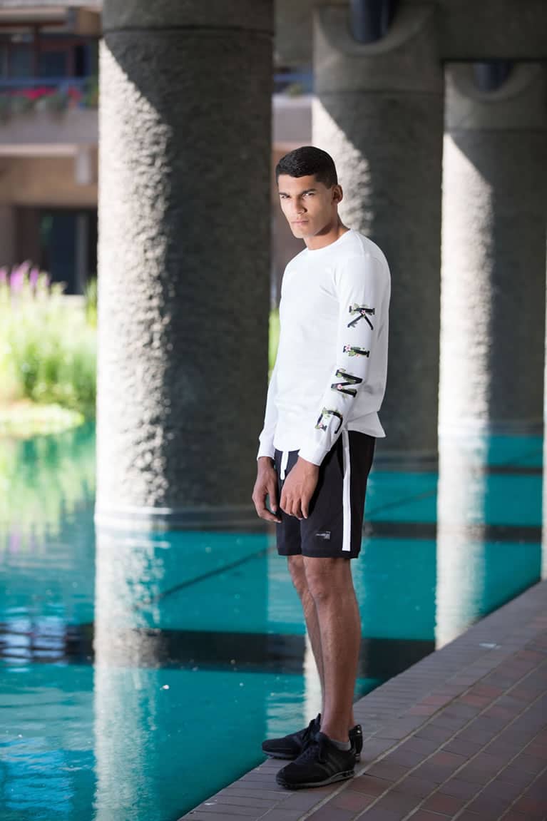 Model wears King Apparel Stepney long sleeve t-shirt in white and Leyton shorts in black