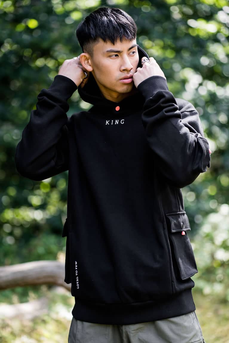 Model wears King Apparel Earlham Techwear hoodie in black