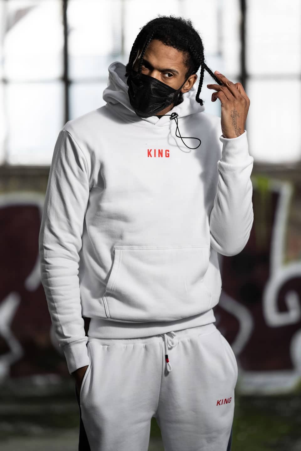 Scorcher wears King Apparel Shadwell hoodie and Manor tracksuit bottoms in white