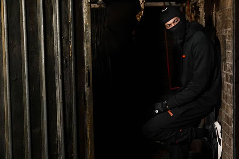 Scorcher wears King Apparel Stepney tracksuit and Earlham Tech balaclava and gloves in black