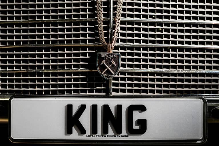 Front of car with Morrisson chain and pendant and KING number plate
