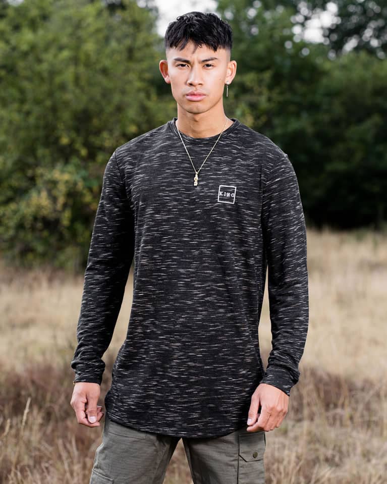 Model wears King Apparel Legacy Interlock lightweight sweatshirt in black fleck