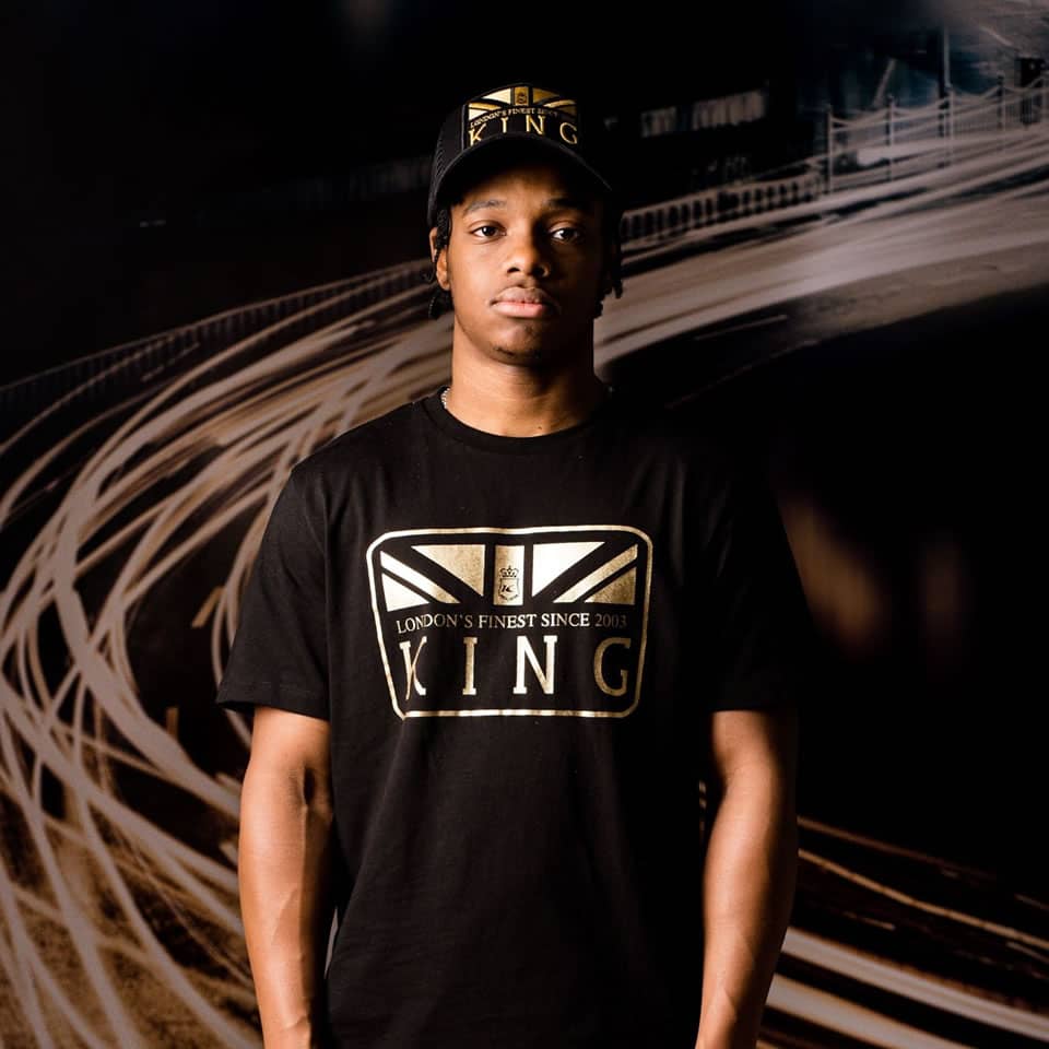 Poundz wears King Apparel Monarch mesh trucker cap and t-shirt in black