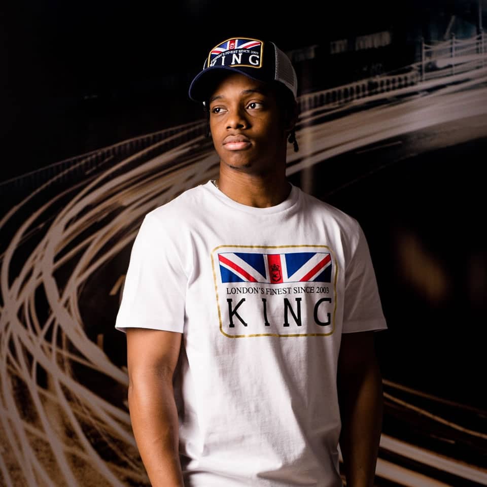 Poundz wears King Apparel Monarch mesh trucker cap in ink blue and t-shirt in white