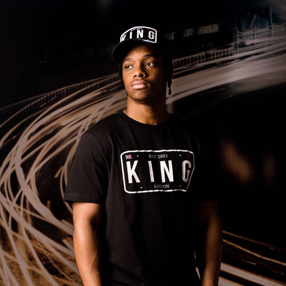 Poundz wears King Apparel Sovereign mesh trucker cap and t-shirt in black