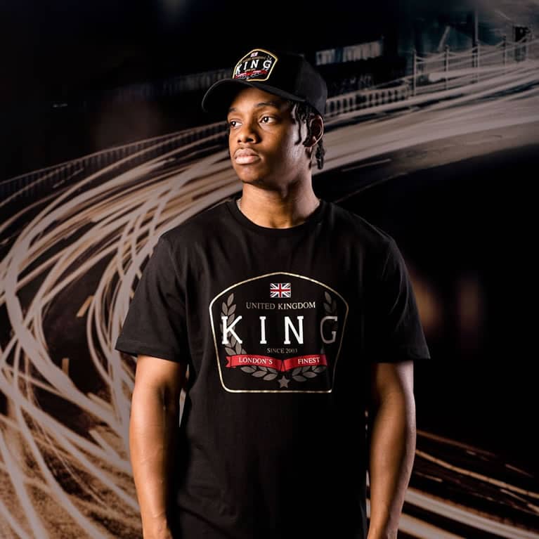 Poundz wears King Apparel Imperial curved peak cap and t-shirt in black