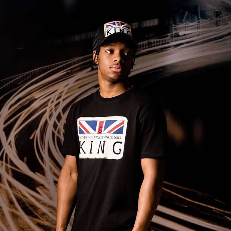 Poundz wears King Apparel Monarch mesh trucker cap and t-shirt in black