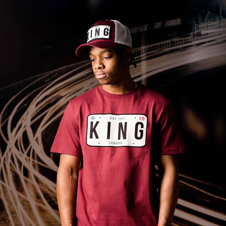 Poundz wears King Apparel Sovereign mesh trucker cap and t-shirt in oxblood red
