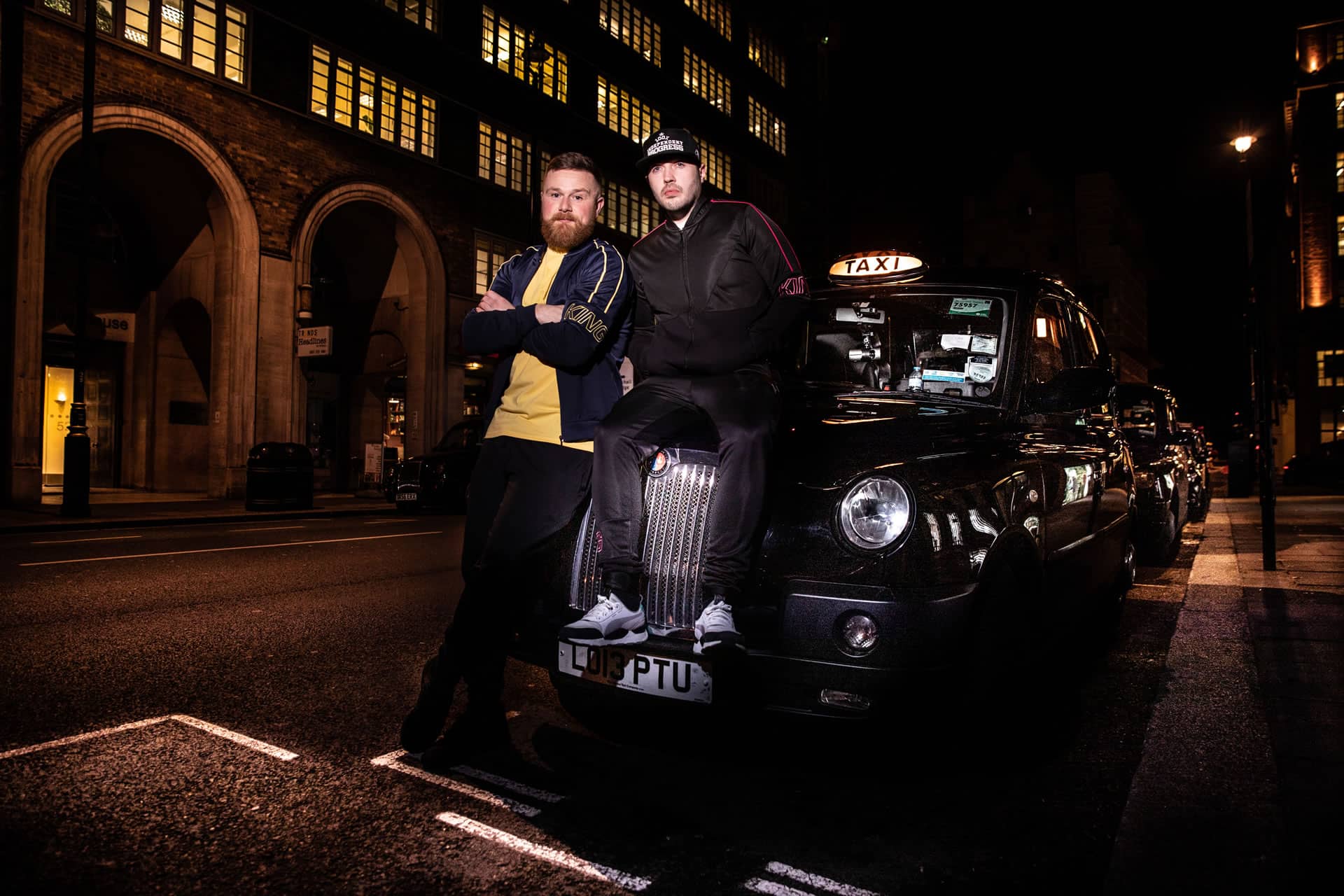Cabbie wears King Apparel Earlham t-shirt in citrus yellow and Earlham tracksuit jacket in ink blue