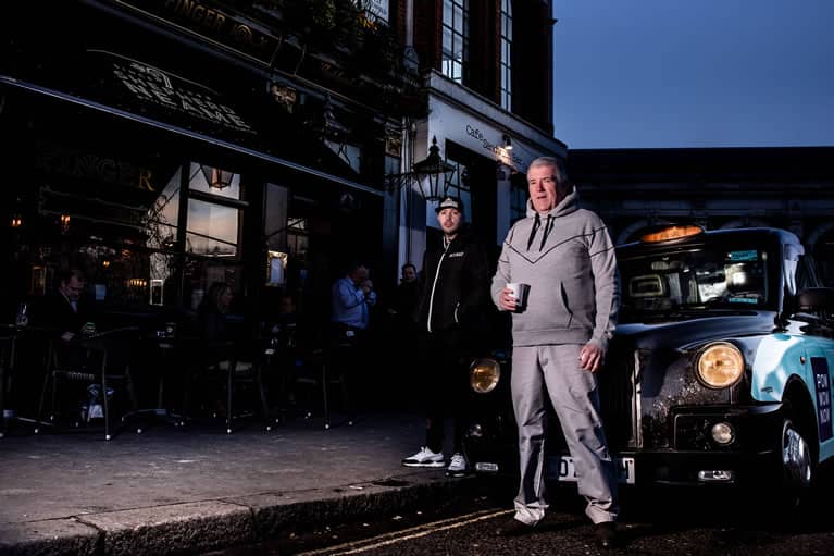 Cabbie wears King Apparel Tennyson tracksuit hoodie in stone grey
