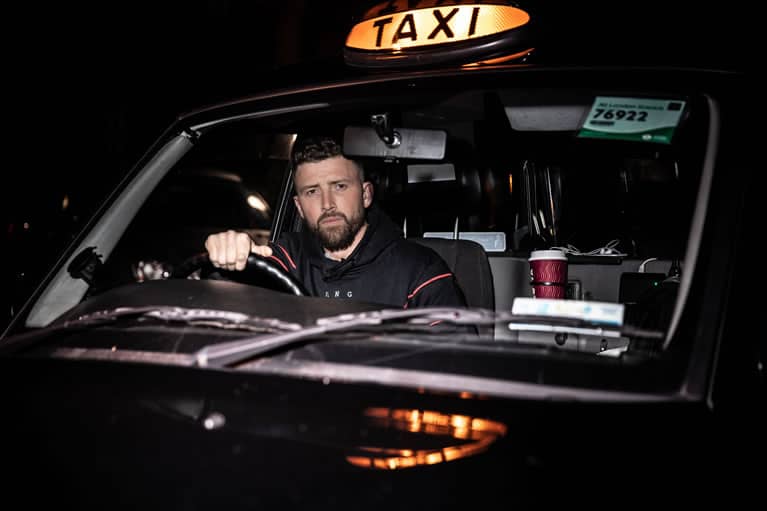 Cabbie wears King Apparel Tennyson tracksuit hoodie in black