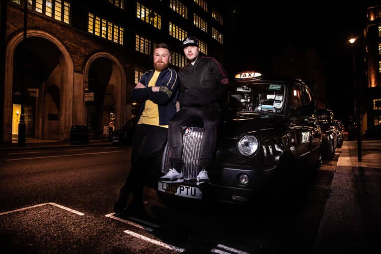 Cabbie wears King Apparel Earlham t-shirt in citrus yellow and Earlham tracksuit jacket in ink blue